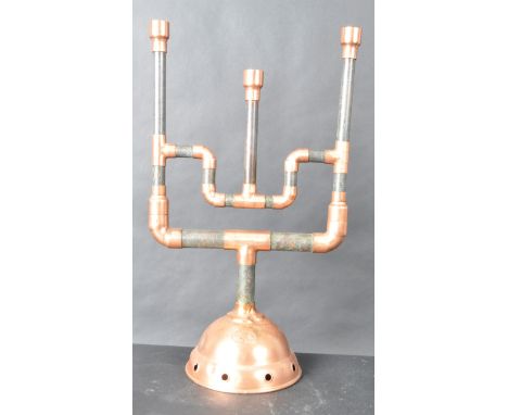 A contemporary Steampunk / upcycled three arm candelabra / candlestick holder constructed from copper pipes and fittings crea