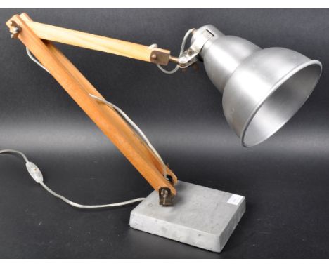 A contemporary industrial style adjustable table / desk lamp light having a brushed metal bell shaped pendant shade supported