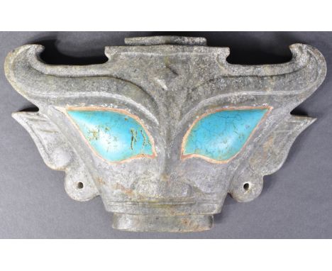A 20th Century Chinese carved stone face mask in the manner of a Shang Dynasty zoomorphic mask of horned Taotie form. The mas