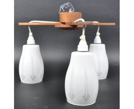 A retro mid 20th Century teak and glass hanging ceiling light having three teak shaped supports with hanging frosted glass sh