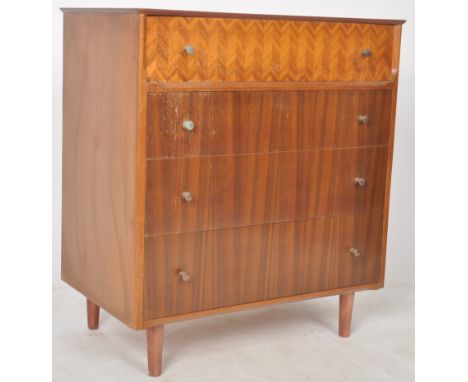 A retro mid Century walnut veneered chest of drawers having a one patterned veneered top drawer over three drawers below all 