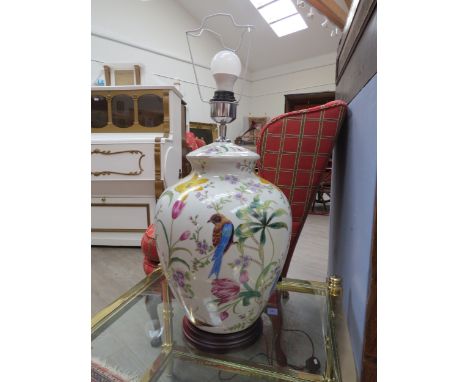 A large crackle glazed table  lamp decorated with birds amongst foliage, raised on a wooden base, 65cm tall
