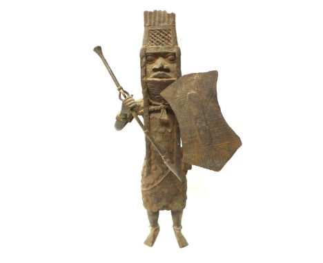 An Edo Benin bronze sculpture of a standing male warrior with spear and shield, 43cm tall