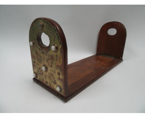 A brass and mahogany book slide with white ceramic roundel (one missing)