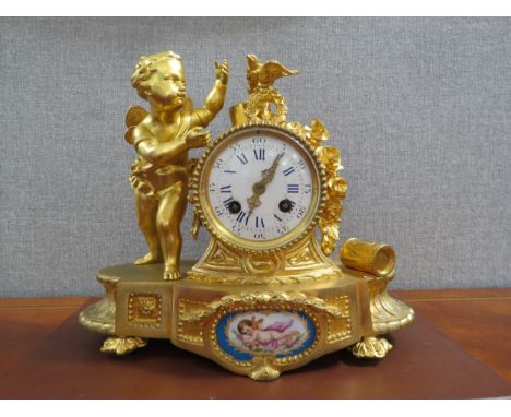 A 19th Century French ormolu mantel clock, the case surmounted by angel, bird, roses and drum.  Two train movement.  25cm x 3