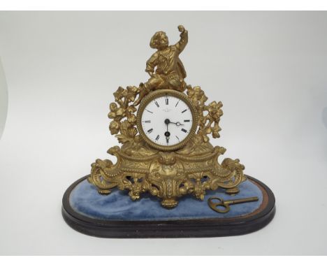 A late 19th century French gilt clock surmounted by a figure with grape bush detail. White enamel roman numeral dial, single 
