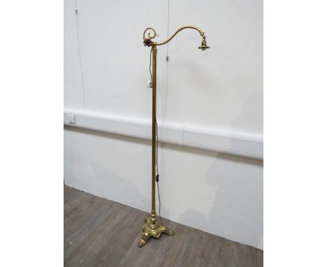 A gilt brass floorstanding reading lamp, scrolled arm, shaped base, no shade