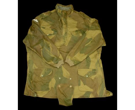 A post Second War Denison smock. A Post Second War Denison smock, green camouflage, with parachutist wings to the right arm, 