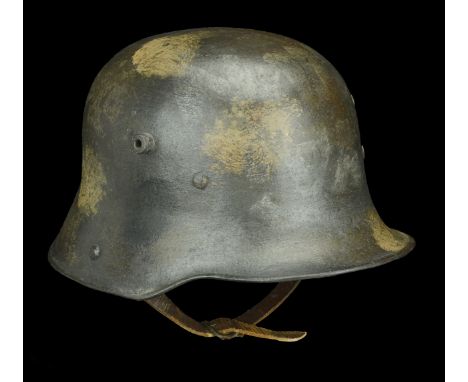 A German Great War Trench Helmet A German M.17 helmet, the skull with a very faint splotch camouflage finish, the M.17 steel 