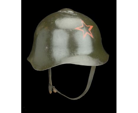 A Russian Second World War Helmet A good and scarce Russian Model 36 helmet complete with all its paint finish. Red star sten