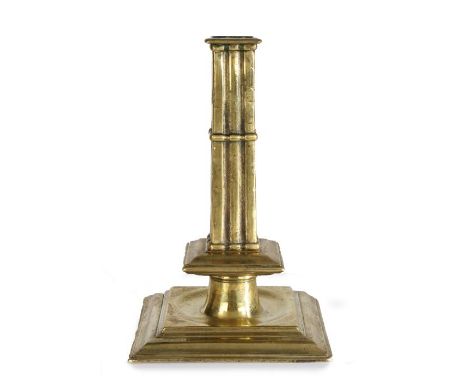 A rare and fine Charles II brass cluster-stem socket candlestick, circa 1680The cast square stem formed as eight conjoined co