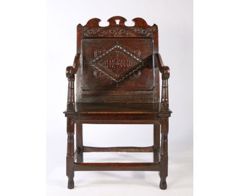 Museum deaccessioned: A Charles II oak panel-back open armchair, Lancashire, circa 1670The back panel carved with a large loz