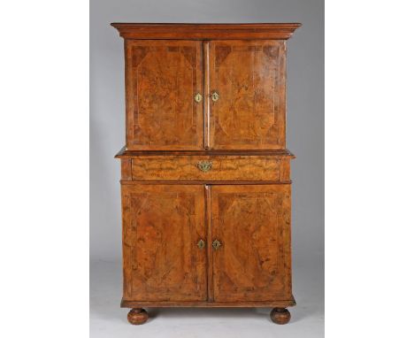 An early 18th century figured-walnut cabinet, English, circa 1720 and laterHaving a pair of boarded doors, veneered in walnut