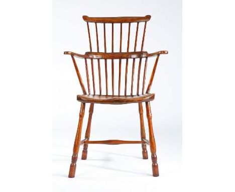 A George III ash and elm comb-back Windsor armchair, West Country, circa 1780-1820Having eight hand-shaped back spindles supp