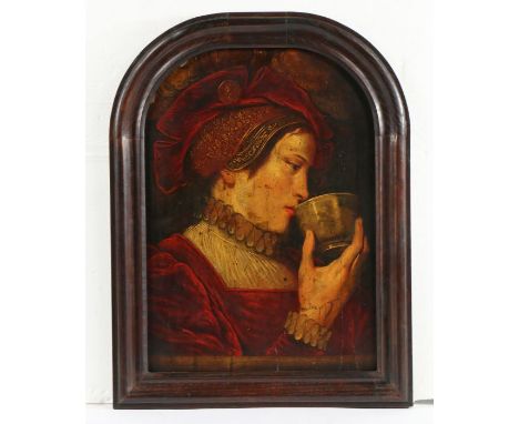 An early 17th century portrait of a lady with cupOil on board, within an arched frame, 53cm wide, 70.5cm highThe reverse of t