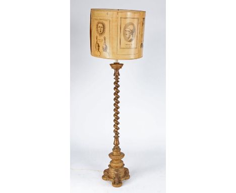 A giltwood standard lamp, having a spiral-turned pillar, on a circular triform base, with shade, 119cm high
