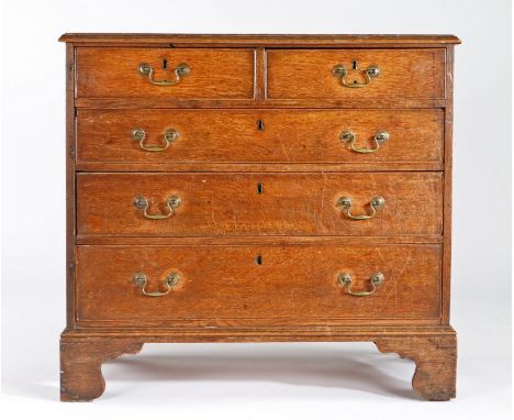 A George III oak chest of drawers, circa 1790Of slender proportions, the rectangular boarded top with applied moulded edge, a