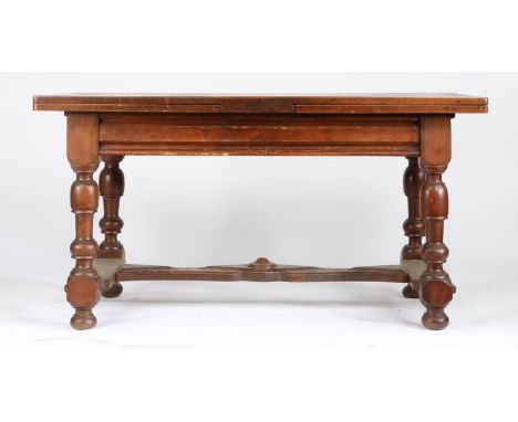 A walnut draw-leaf table, French, circa 1800Having a fully-cleated twin-plank top, a draw-leaf to each end above a small frie