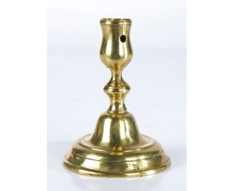 An early 18th century brass candlestick, Dutch, circa 1720The seamed tulip-shaped socket with circular extraction hole and sh