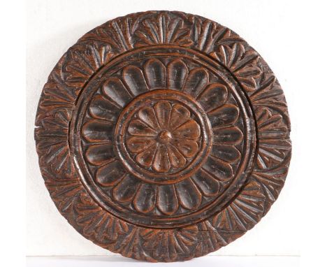 An 18th/19th century oak cheese print mould or cheese vat lidOf circular form, carved to the centre with an eight-petal flowe