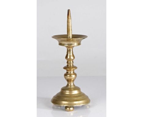 A 16th century brass pricket candlestick, German or Flemish, circa 1550With flared drip tray, balustroid and discoid stem, on