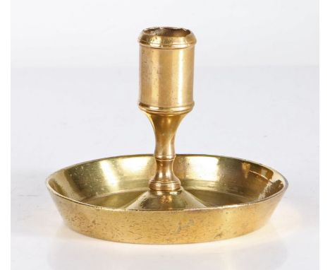 An early 18th century brass dwarf or possible lantern candlestick, circa 1730-40The socket with moulded rim, on a short waist