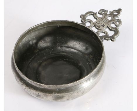 A Charles II pewter porringer, circa 1680

Having an old-English-ear, stamped with the ownership triad ‘P’ over ‘DA’, and wit