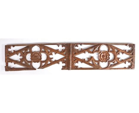 A large mid-15th century carved oak and pierced tracery panel, circa 1450Designed as two reserves, each centred by a flower-f