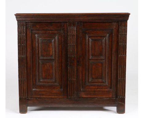 A small late 17th century oak and walnut side cabinet, circa 1680Having a one-piece walnut top with applied moulded edge, ato