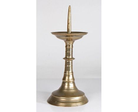 A 16th century 'red-brass' pricket candlestick, German, circa 1500-50With tall pricket, linear incised drip-tray, ribbed and 