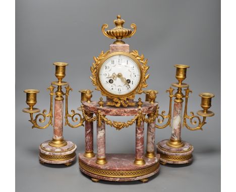A French ormulu and rouge marble clock garniture, c.1900, with decorative enamel dial, 40cms high.