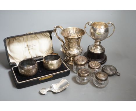 A Victorian repousse silver christening mug, Birmingham, 1861, 9.5cm, a cased pair of silver napkin rings, four assorted silv