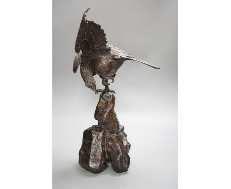 A Japanese bronze model of an eagle on a rock, Meiji period, 40cms high.