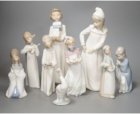 Seven Lladro figures together with two Nao figures. Tallest 29cm