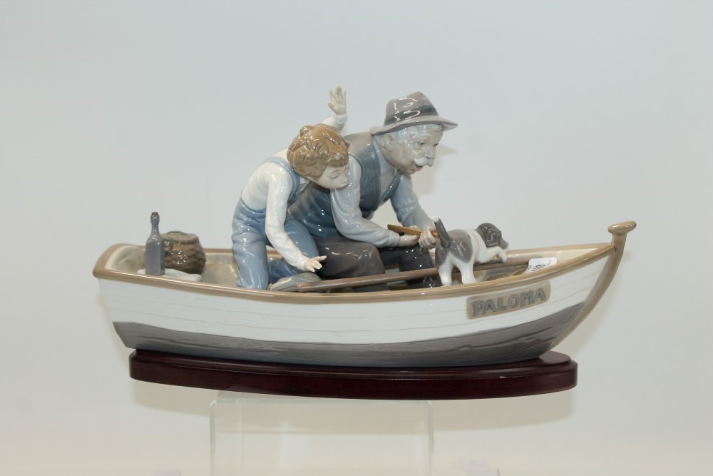 Lladro porcelain figure group Fisherman with boy and dog in a rowing boat, on plinth base CONDI