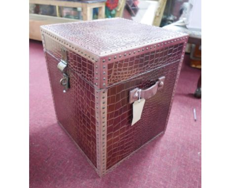 A burgundy faux crocodile skin travelling trunk. H55 W.45 D.45cm 