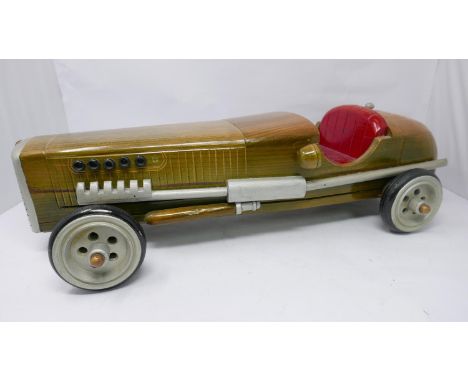 A wooden model of a vintage racing car 