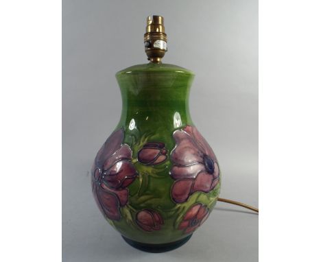 A Moorcroft Table Lamp Decorated in the Poppy Pattern on Green Ground. 32cm High
