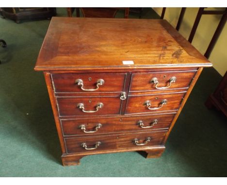 A Georgian Mahogany Commode Chest in the form of a Chest of Four Short and Two Long Drawers on Bracket Feet