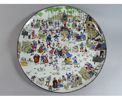 A Continental Ceramic Charger Decorated with Figures in Village Fair. (Stapled) 41cm Diameter.