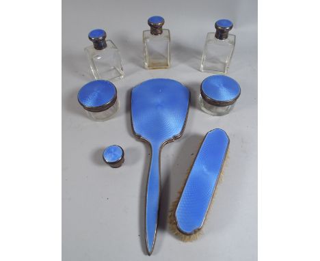 A Nine Piece Silver and Blue Enamel Dressing Table Set. London 1933