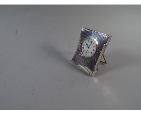 A Small Silver Easel Back Traveling Clock with Swiss Movement. Bham Hallmark 1920. 7.5cm High