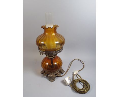 A Large Brass and Amber Glass Table Lamp in the Form of an Oil Lamp.