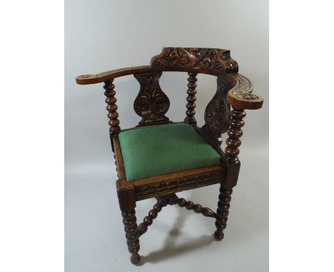 A Late Victorian Carved Oak Corner Armchair with Bobbin Supports and Stretchers. Carved Swan Backrest. 