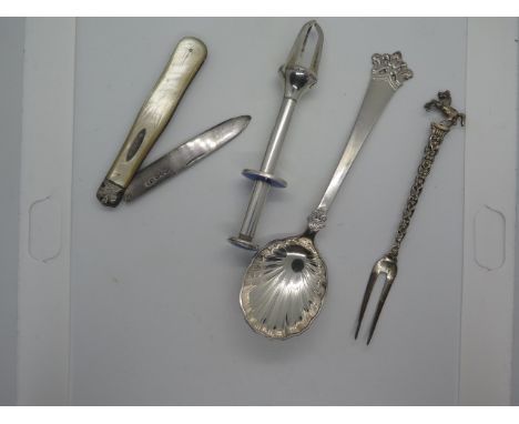 A small collection of silver to include continental pickle fork, Scandinavian spoon, silver plate and enamel, pickle grab and
