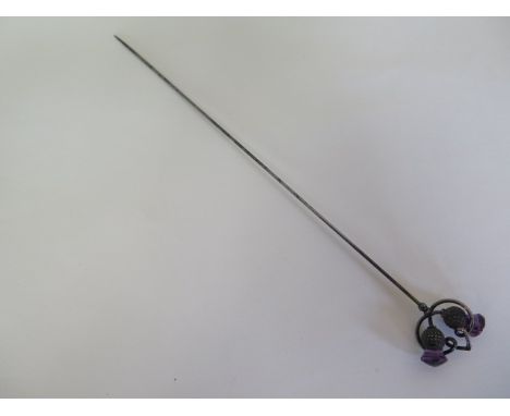 A silver Charles Horner hat pin of double thistle design, set with amethyst stones - 23cm long - generally good condition 