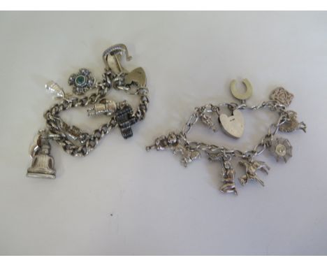 Two silver charm bracelets with various silver and white metal charms - approx 70 grams 