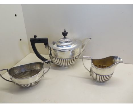 A Harlequin silver three piece tea service, various makers and dates but same design, weight approx 28.4 troy oz, some light 