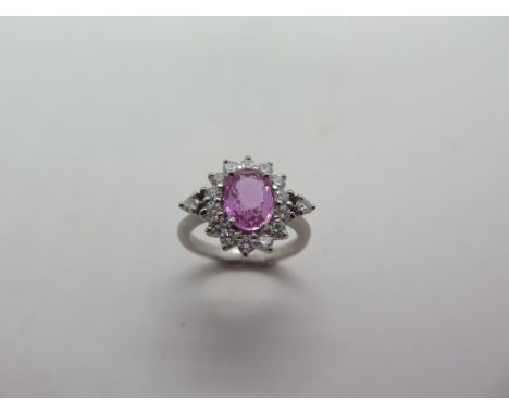 An 18ct hallmarked white gold diamond and pink sapphire ring, head 13x10mm, ring size K, in good condition 