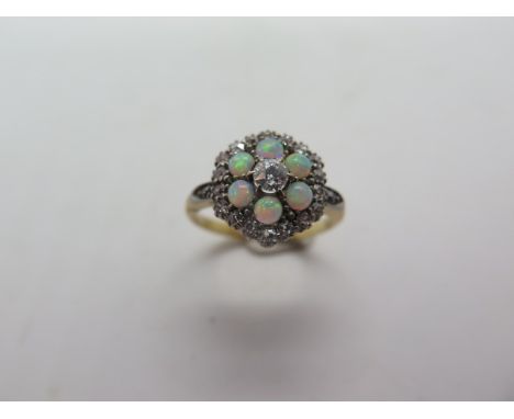 An 18ct yellow gold diamond and opal cluster ring, head approx 12mm diameter, ring size M, approx 4 grams, in good condition,